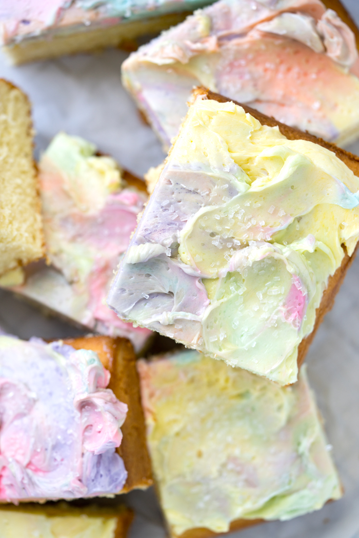 Rainbow Frosted Sheet Cake. I'm in love with this simple, moist yellow cake enrobed in a blanket of rainbow swirled swiss meringue buttercream. | thesugarcoatedcottage.com