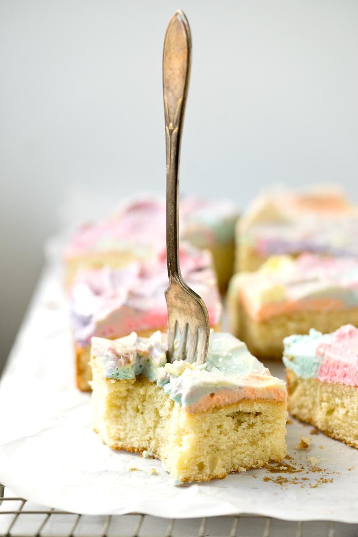 Rainbow Frosted Sheet Cake. I'm in love with this simple, moist yellow cake enrobed in a blanket of rainbow swirled swiss meringue buttercream. | thesugarcoatedcottage.com