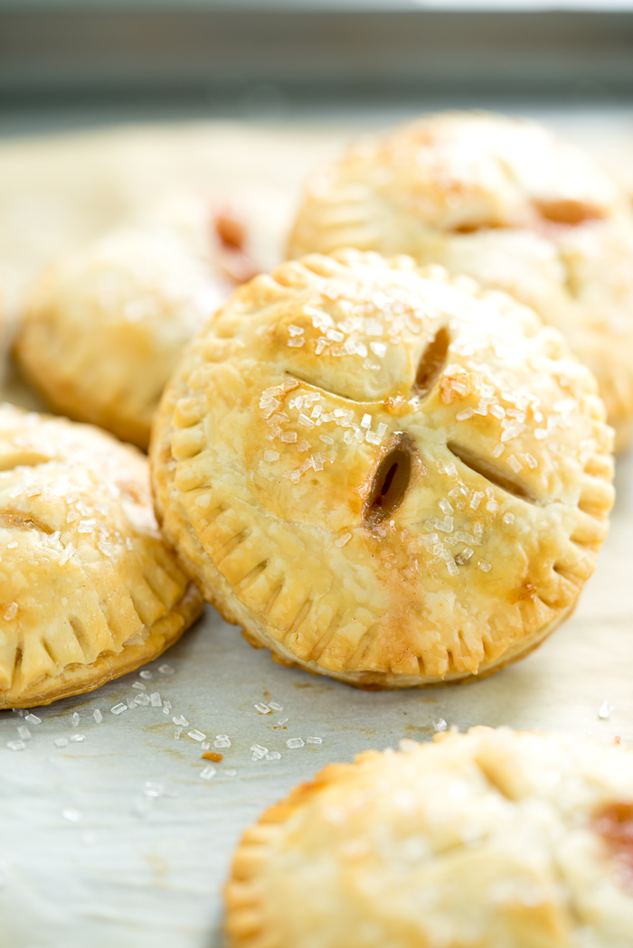 Easy Peachy Hand Pies. Sweet, juicy, ripe peaches in cute little individual buttery crusted hand pies. You'll love to bake of this recipe! | thesugarcoatedcottage.com