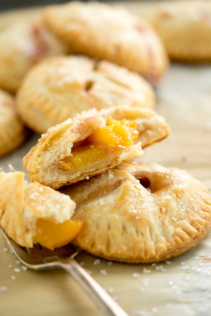 Easy Peachy Hand Pies. Sweet, juicy, ripe peaches in cute little individual buttery crusted hand pies. You'll love to bake of this recipe! | thesugarcoatedcottage.com