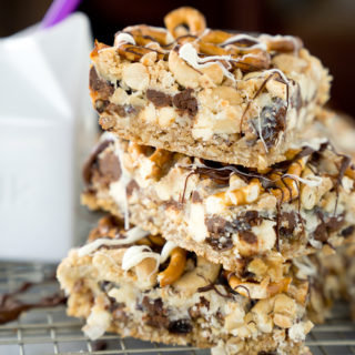 Magical Oatmeal Nutty Toffee Bar recipe. Oatmeal raisin base topped with pecans, walnuts, cashews, chocolate, toffee, coconut and pretzels! Trust me, you need these. | thesugarcoatedcottage.com