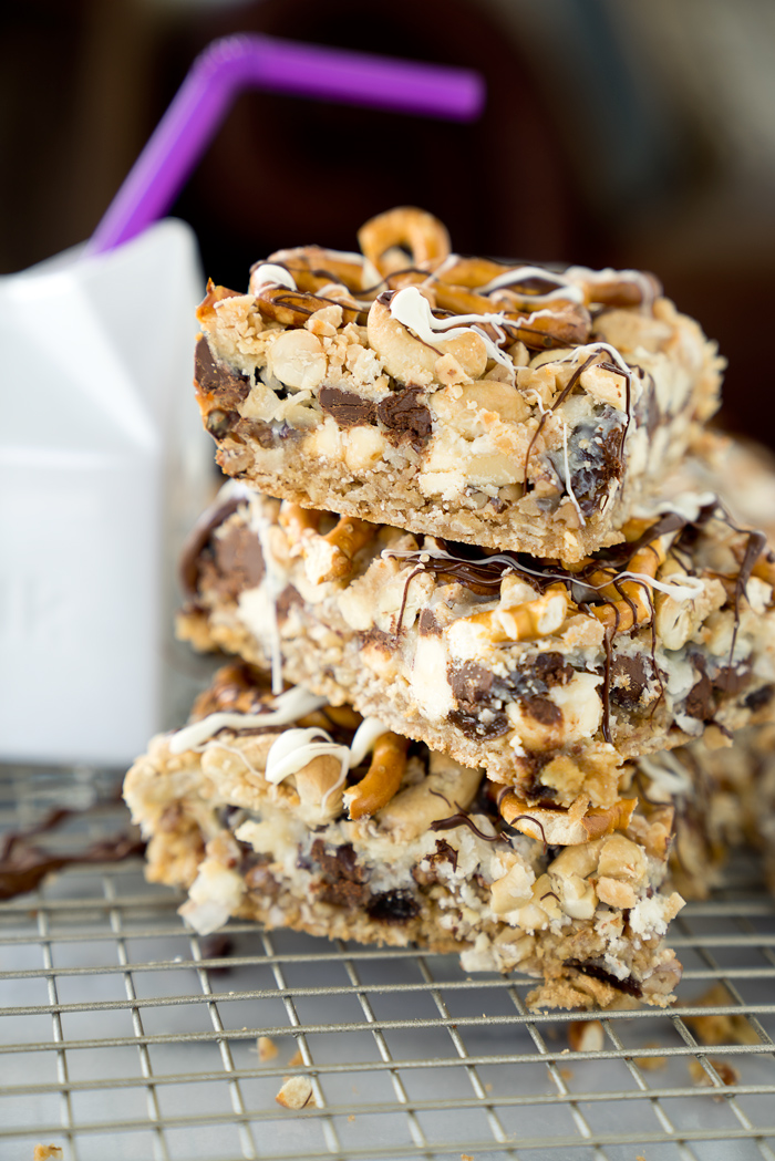 Magical Oatmeal Nutty Toffee Bar recipe. Oatmeal raisin base topped with pecans, walnuts, cashews, chocolate, toffee, coconut and pretzels! Trust me, you need these. | thesugarcoatedcottage.com