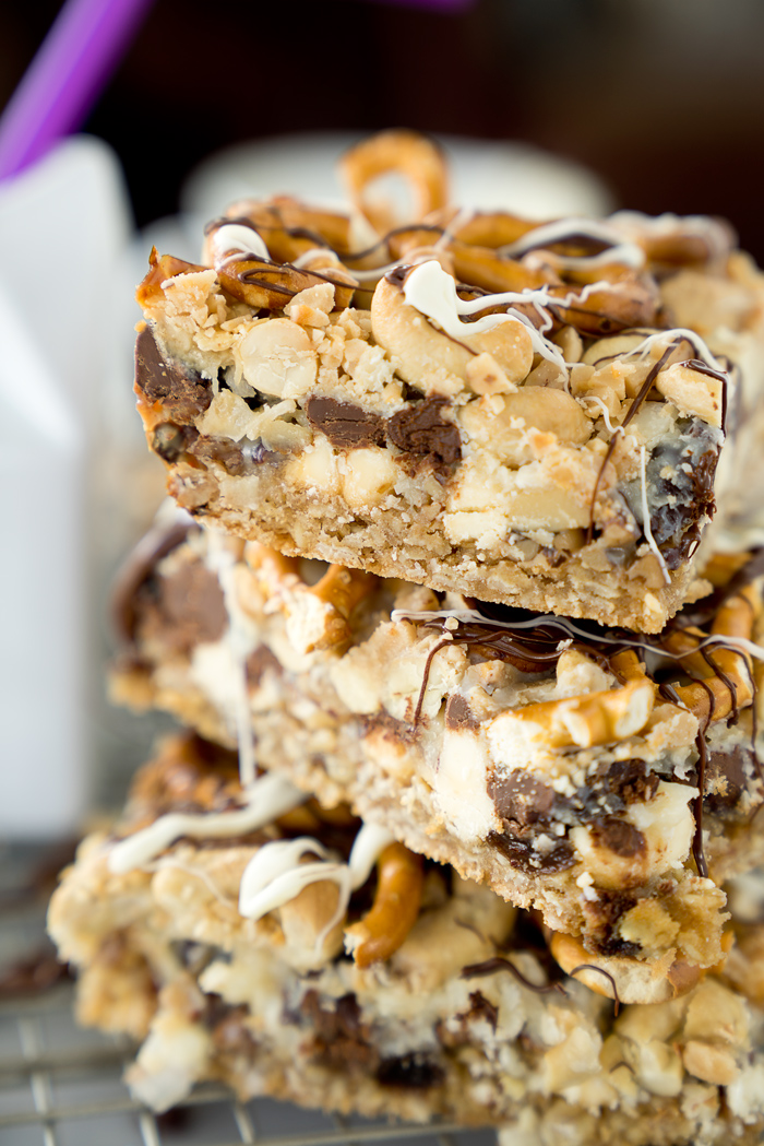 Magical Oatmeal Nutty Toffee Bar recipe. Oatmeal raisin base topped with pecans, walnuts, cashews, chocolate, toffee, coconut and pretzels! Trust me, you need these. | thesugarcoatedcottage.com