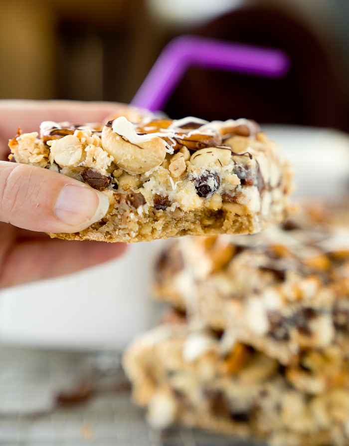 Magical Oatmeal Nutty Toffee Bar recipe. Oatmeal raisin base topped with pecans, walnuts, cashews, chocolate, toffee, coconut and pretzels! Trust me, you need these. | thesugarcoatedcottage.com