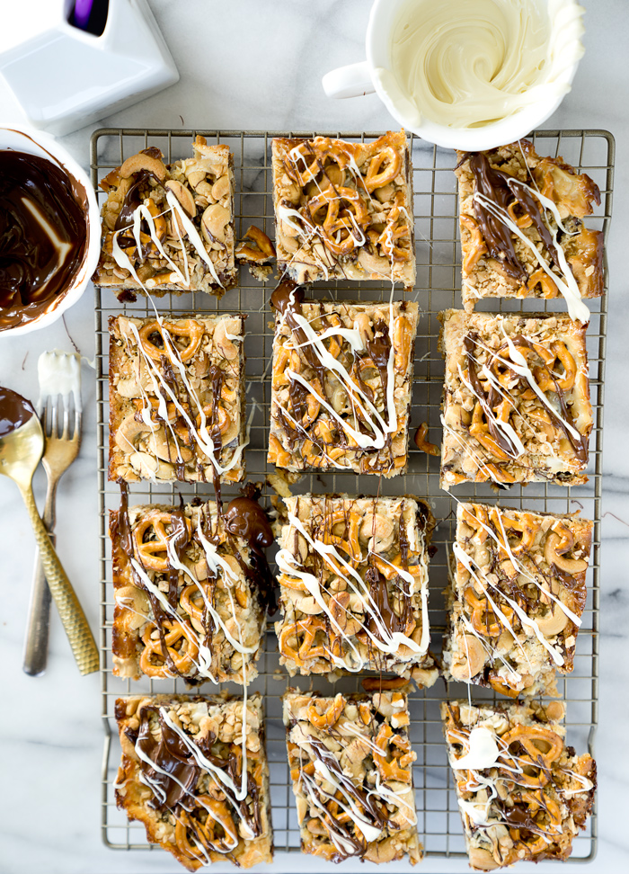 Magical Oatmeal Nutty Toffee Bar recipe. Oatmeal raisin base topped with pecans, walnuts, cashews, chocolate, toffee, coconut and pretzels! Trust me, you need these. | thesugarcoatedcottage.com