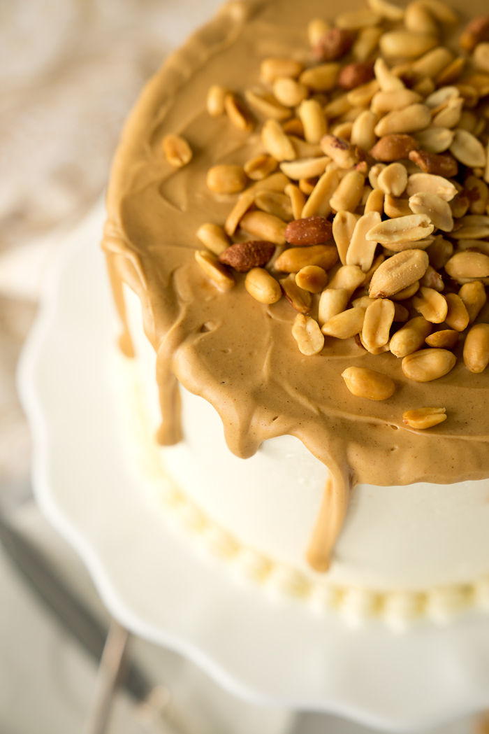 Dreamy White Chocolate Peanut Butter Cake Recipe. I'm in love with layers of white chocolate cake, white chocolate buttercream and creamy peanut butter ganache!! | thesugarcoatedcottage.com