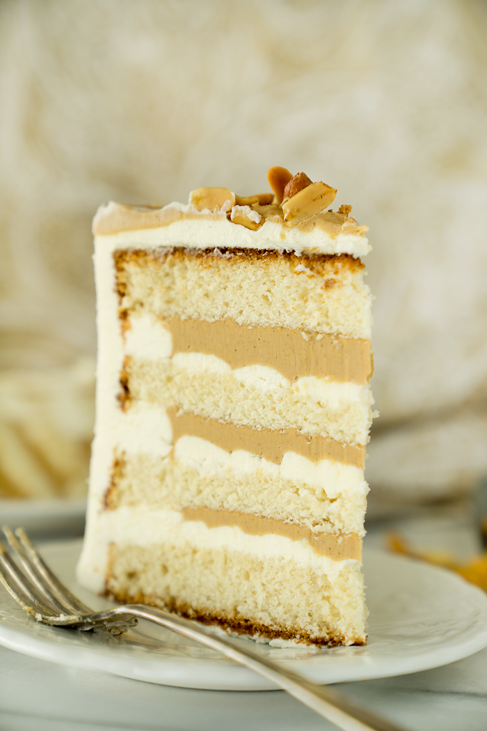 Dreamy White Chocolate Peanut Butter Cake Recipe. I'm in love with layers of white chocolate cake, white chocolate buttercream and creamy peanut butter ganache!! | thesugarcoatedcottage.com