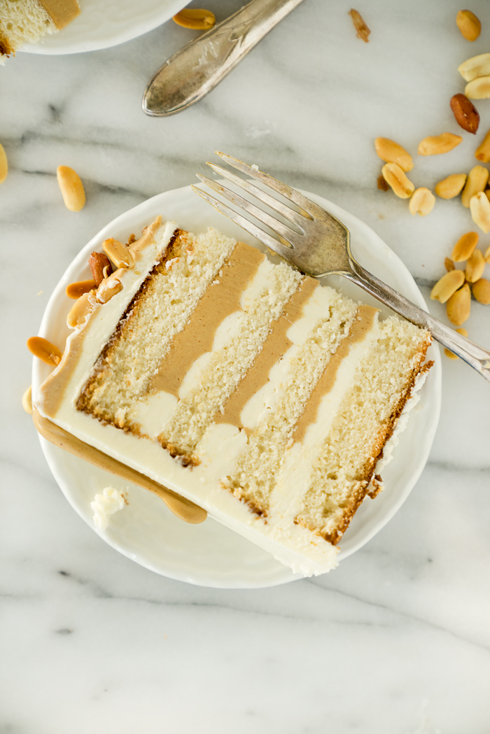 Dreamy White Chocolate Peanut Butter Cake Recipe. I'm in love with layers of white chocolate cake, white chocolate buttercream and creamy peanut butter ganache!! | thesugarcoatedcottage.com