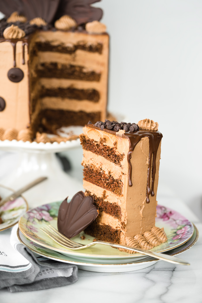 Chocolate On Chocolate Cake recipe. Chocolatey rich cake covered in a blanket of creamy Chocolate Swiss Meringue Buttercream. Dripping with chocolate ganache and adorned by more chocolate. | thesugarcoatedcottage.com