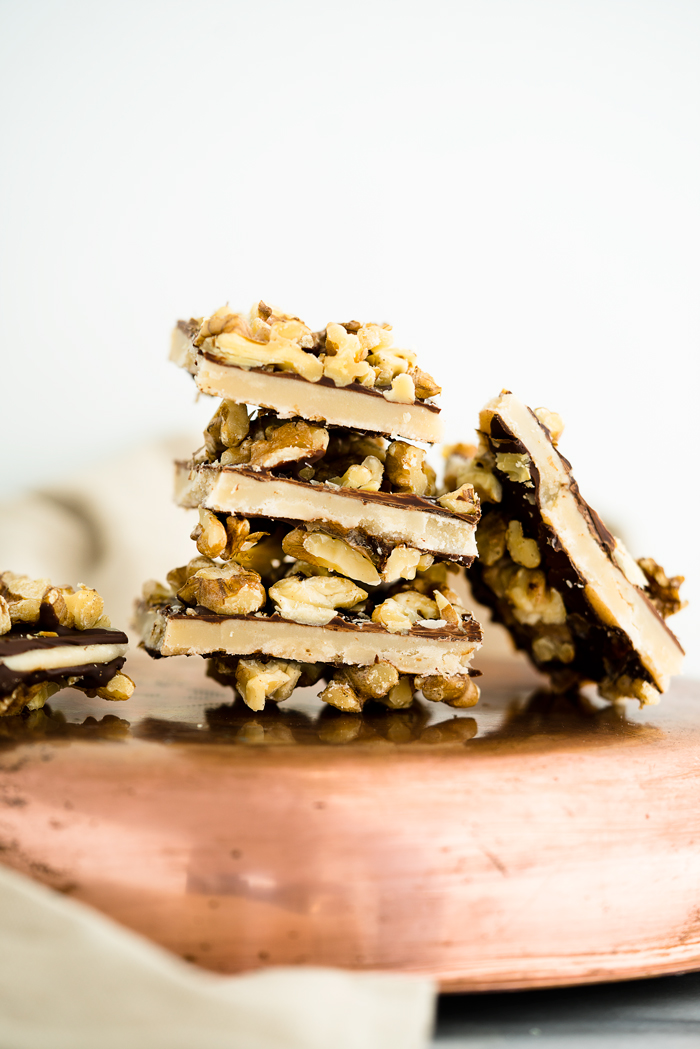 Chocolate Walnut Butter Crunch recipe!! Buttery, crunchy candy center coated in chocolate and sprinkled with roasted walnuts. | thesugarcoatedcottage.com