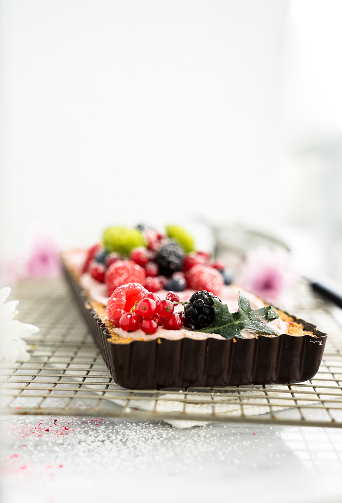 Raspberry Ganache Tart recipe. Smooth, rich and creamy raspberry ganache wrapped in a crunchy cookie crust. | thesugarcoatedcottage.com