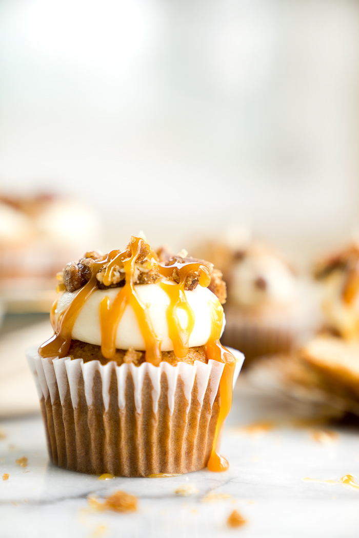 Candied Pecan Banana Cupcake Recipe. Easy stove top candied pecans crumbled on top of cream cheese frosting, drizzled with butterscotch on top of a sweet banana cupcake! | thesugarcoatedcottage.com, candied pecans, cream cheese frosting, butterscotch, banana, recipe, cupcake. #cupcake #recipe