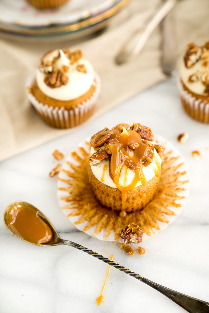 Candied Pecan Banana Cupcake Recipe. Easy stove top candied pecans crumbled on top of cream cheese frosting, drizzled with butterscotch on top of a sweet banana cupcake! | thesugarcoatedcottage.com, candied pecans, cream cheese frosting, butterscotch, banana, recipe, cupcake. #cupcake #recipe