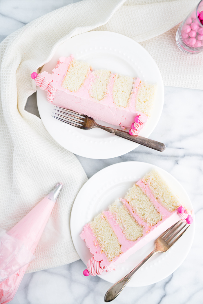 Its a Girl Baby Shower Cake Recipe! White Chocolate Cake coated in a delicate pink white chocolate swiss meringue buttercream. Pink cake, frosting, buttercream, baby shower, cake. | thesugarcoatedcottage.com