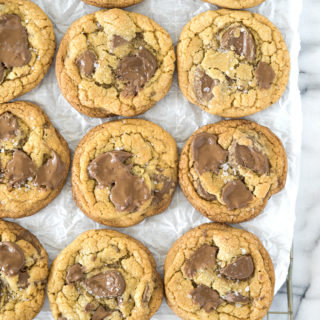 Valrhona Hazelnut Milk Chocolate Chip Cookie Recipe. This fabulous cookie is studded with Valrhona Hazelnut Milk Chocolate Feves (chips) and sprinkled with sea salt. Luxurious, smooth and creamy sums up this cookie! | thesugarcoatedcottage.com #valrhona #chocolatechipcookie #milk chocolate