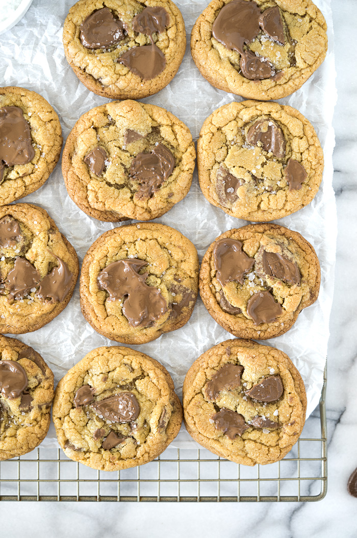 Valrhona Hazelnut Milk Chocolate Chip Cookie Recipe. This fabulous cookie is studded with Valrhona Hazelnut Milk Chocolate Feves (chips) and sprinkled with sea salt. Luxurious, smooth and creamy sums up this cookie! | thesugarcoatedcottage.com #valrhona #chocolatechipcookie #milk chocolate