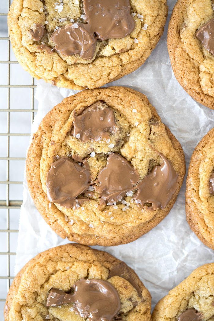 Valrhona Hazelnut Milk Chocolate Chip Cookie Recipe. This fabulous cookie is studded with Valrhona Hazelnut Milk Chocolate Feves (chips) and sprinkled with sea salt. Luxurious, smooth and creamy sums up this cookie! | thesugarcoatedcottage.com #valrhona #chocolatechipcookie #milk chocolate