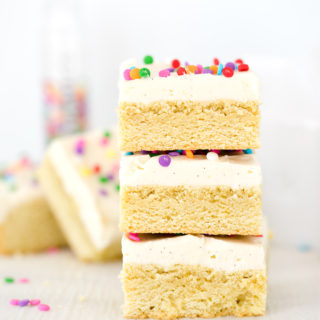 Vanilla Bean Buttercream Frosted Sugar Cookie Bar Recipe. Smooth, creamy vanilla bean flecked swiss meringue buttercream on top of sweet, buttery, sugar cookie bars. | thesugarcoatedcottage.com #recipe #cookies #baking #sugarcookie #buttercream