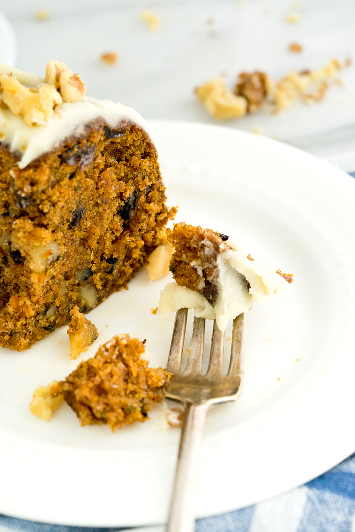 Rum Raisin Carrot Bundt Cake Recipe. Moist, dense, spiced carrot cake with spiced rum soaked raisins and buttery rum icing. The best carrot cake! | thesugarcoatedcottage.com #cake #carrotcake #bundtcake