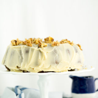 Rum Raisin Carrot Bundt Cake Recipe. Moist, dense, spiced carrot cake with spiced rum soaked raisins and buttery rum icing. The best carrot cake! | thesugarcoatedcottage.com #cake #carrotcake #bundtcake