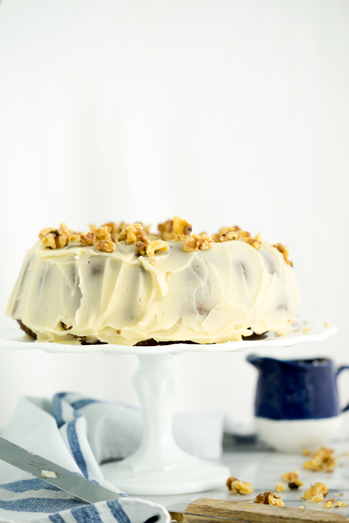 Rum Raisin Carrot Bundt Cake Recipe. Moist, dense, spiced carrot cake with spiced rum soaked raisins and buttery rum icing. The best carrot cake! | thesugarcoatedcottage.com #cake #carrotcake #bundtcake