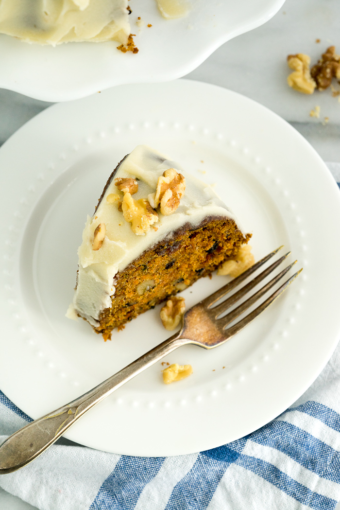 Rum Raisin Carrot Bundt Cake Recipe. Moist, dense, spiced carrot cake with spiced rum soaked raisins and buttery rum icing. The best carrot cake! | thesugarcoatedcottage.com #cake #carrotcake #bundtcake