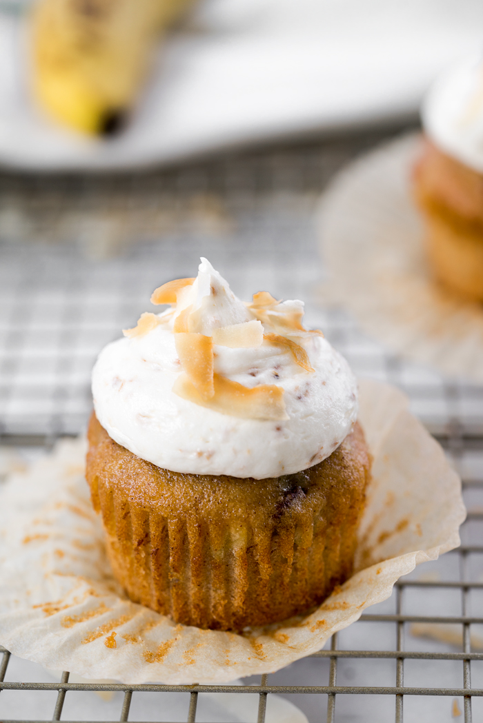 Hummingbird Cupcakes & Toasted Coconut Buttercream. A southern classic topped with a swirl of smooth and creamy toasted coconut buttercream. | thesugarcoatedcottage.com #banana #cupcake #hummingbird