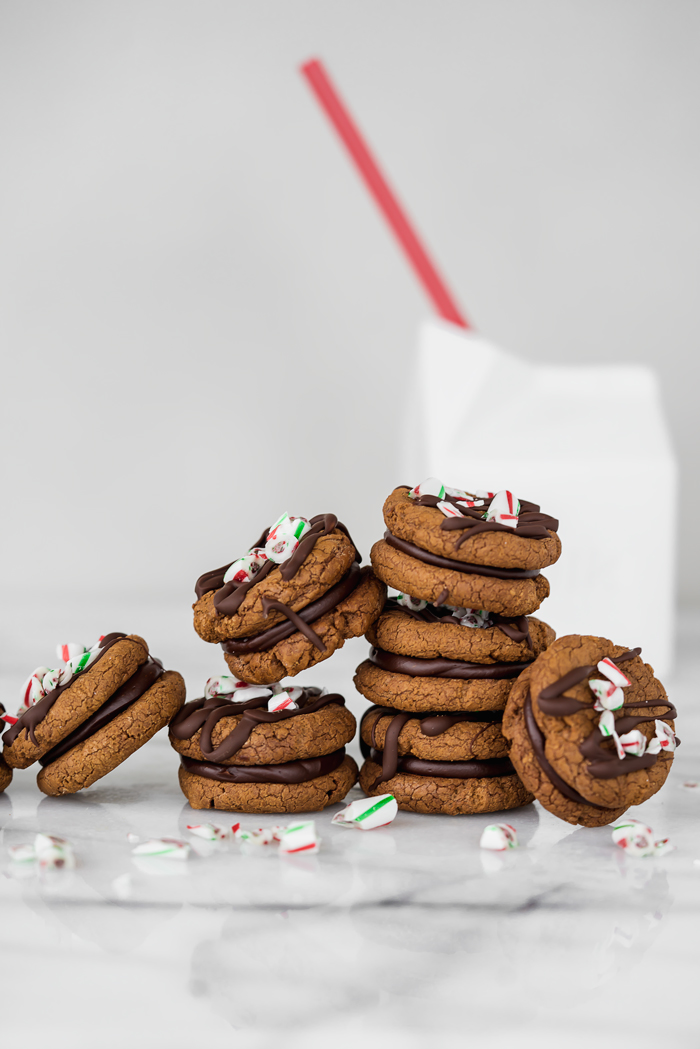 Peppermint Ganache Sandwich Cookies. Crunchy on the outside, soft on the inside chocolate cookies sandwich smooth and creamy peppermint ganache! | www.thesugarcoatedcottage.com | @NielsenMassey, cookies, ganache, sandwich cookie, oreo, peppermint, holiday, christmas