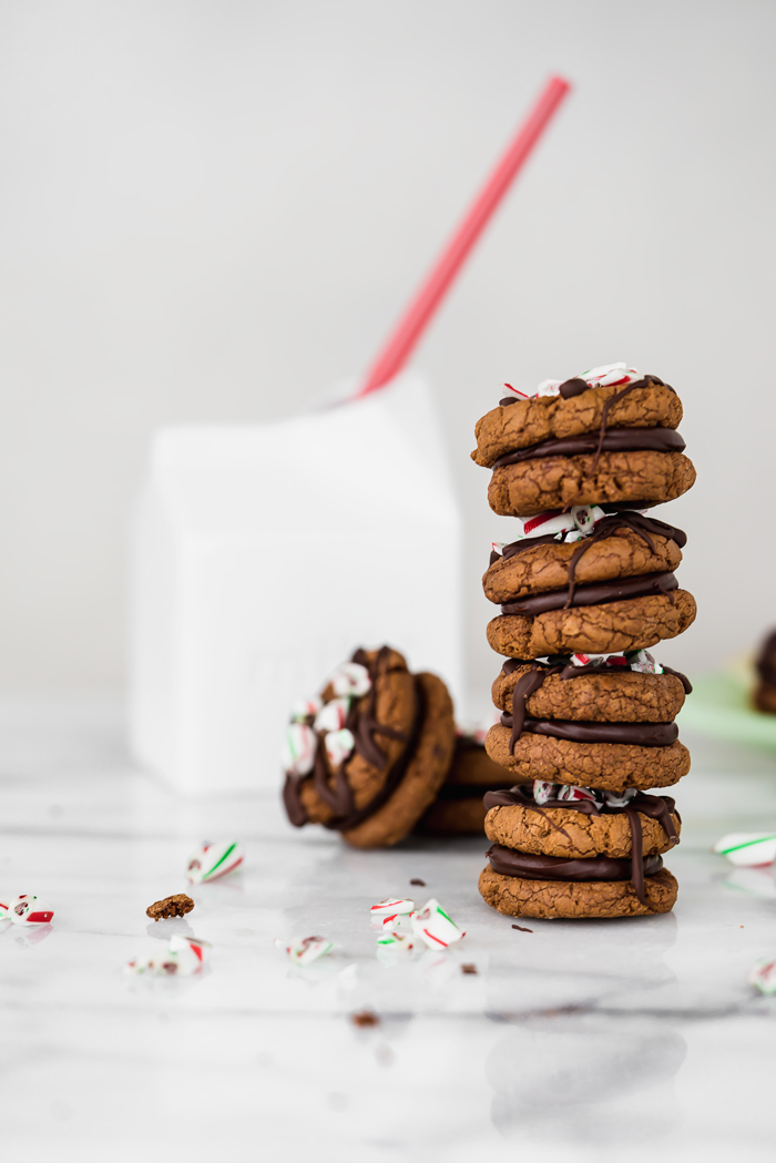 Peppermint Ganache Sandwich Cookies. Crunchy on the outside, soft on the inside chocolate cookies sandwich smooth and creamy peppermint ganache! | www.thesugarcoatedcottage.com | @NielsenMassey, cookies, ganache, sandwich cookie, oreo, peppermint, holiday, christmas