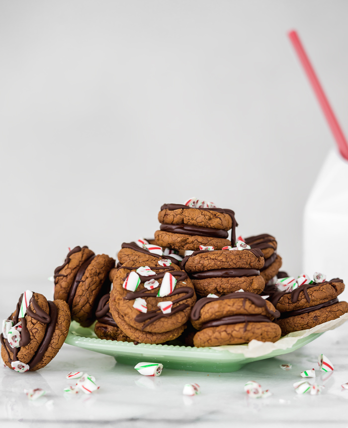 Peppermint Ganache Sandwich Cookies. Crunchy on the outside, soft on the inside chocolate cookies sandwich smooth and creamy peppermint ganache! | www.thesugarcoatedcottage.com | @NielsenMassey, cookies, ganache, sandwich cookie, oreo, peppermint, holiday, christmas