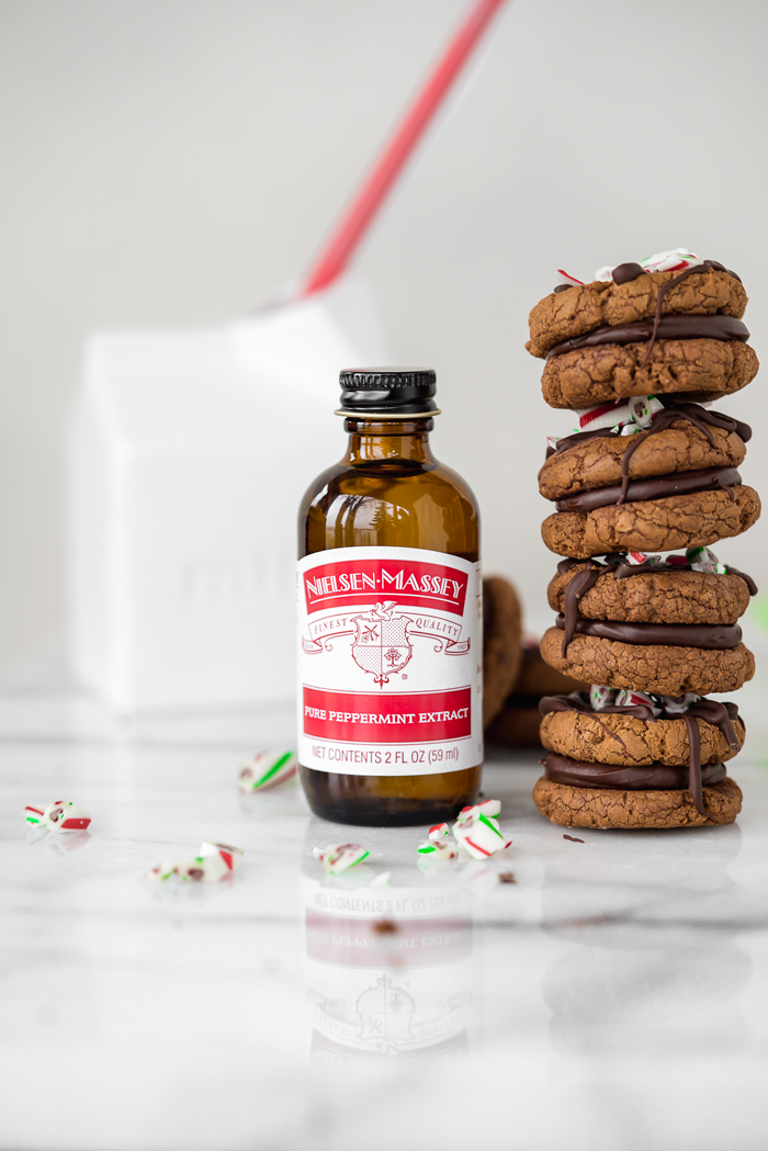 Peppermint Ganache Sandwich Cookies. Crunchy on the outside, soft on the inside chocolate cookies sandwich smooth and creamy peppermint ganache! | www.thesugarcoatedcottage.com | @NielsenMassey, cookies, ganache, sandwich cookie, oreo, peppermint, holiday, christmas