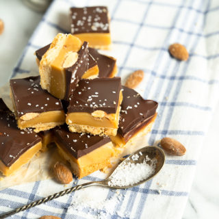 Roasted Almond Millionaire Shortbread - shortbread cookie base, generous caramel layer, roasted almonds, blanket of chocolate and a sprinkling of sea salt. #twix #millionaireshortbread #shortbread #cookie | thesugarcoatedcottage.com