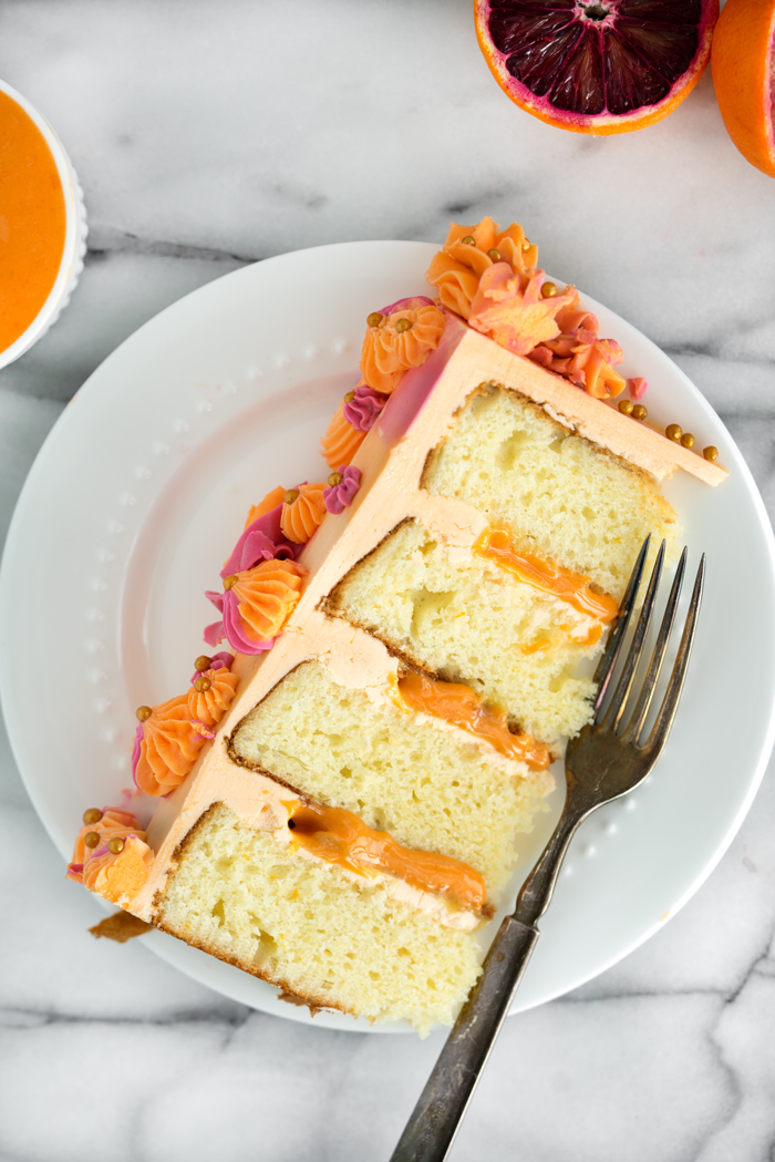 Blood Orange Cake. Blood orange scented cake layered with fresh blood orange curd. | thesugarcoatedcottage.com #bloodorange #orangecurd #cake #buttercream