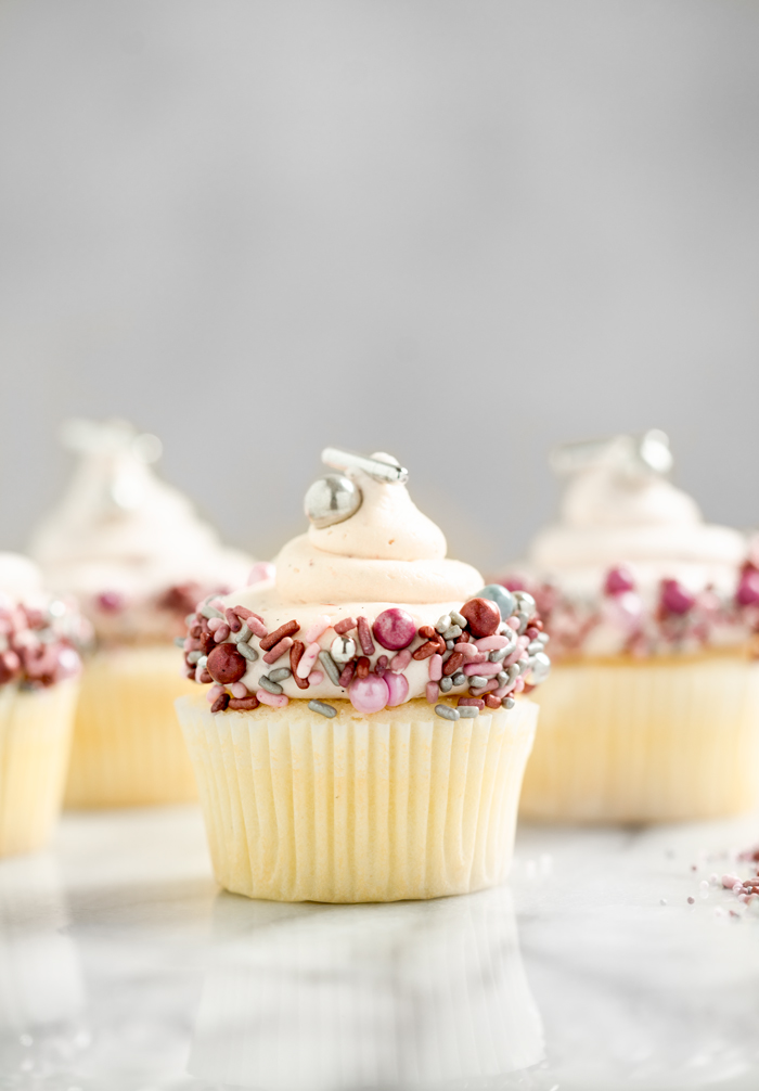 White Chocolate Strawberry filled cupcakes. White chocolate strawberry buttercream on top of a strawberry puree filled cupcake!! #cupcakes #buttercream | thesugarcoatedcottage.com