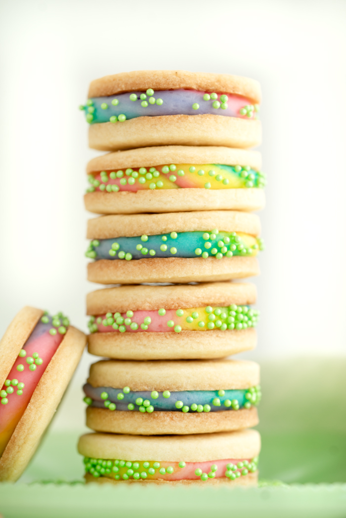 Buttercream Sandwich Cookie Recipe. Crispy sugar cookies sandwiching sweet buttercream. | thesugarcoatedcottage.com #cookies #buttercream #sandwich #rainbow