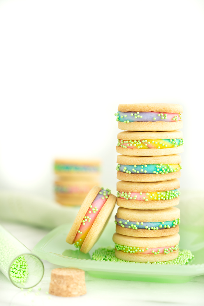 Buttercream Sandwich Cookie Recipe. Crispy sugar cookies sandwiching sweet buttercream. | thesugarcoatedcottage.com #cookies #buttercream #sandwich #rainbow