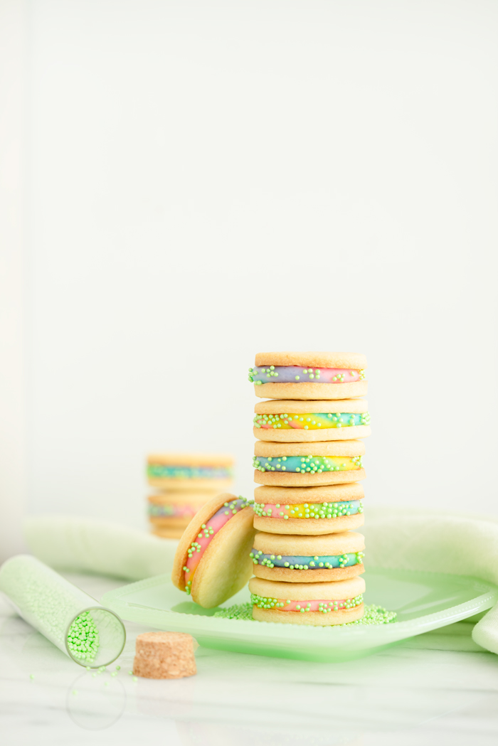 Buttercream Sandwich Cookie Recipe. Crispy sugar cookies sandwiching sweet buttercream. | thesugarcoatedcottage.com #cookies #buttercream #sandwich #rainbow