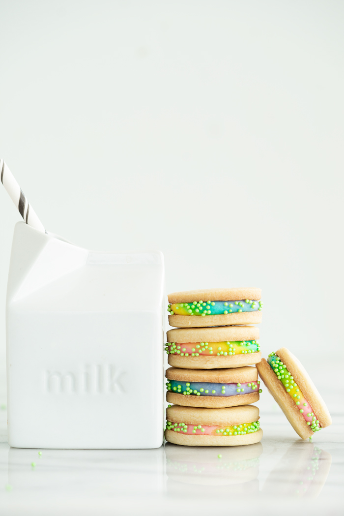 Buttercream Sandwich Cookie Recipe. Crispy sugar cookies sandwiching sweet buttercream. | thesugarcoatedcottage.com #cookies #buttercream #sandwich #rainbow