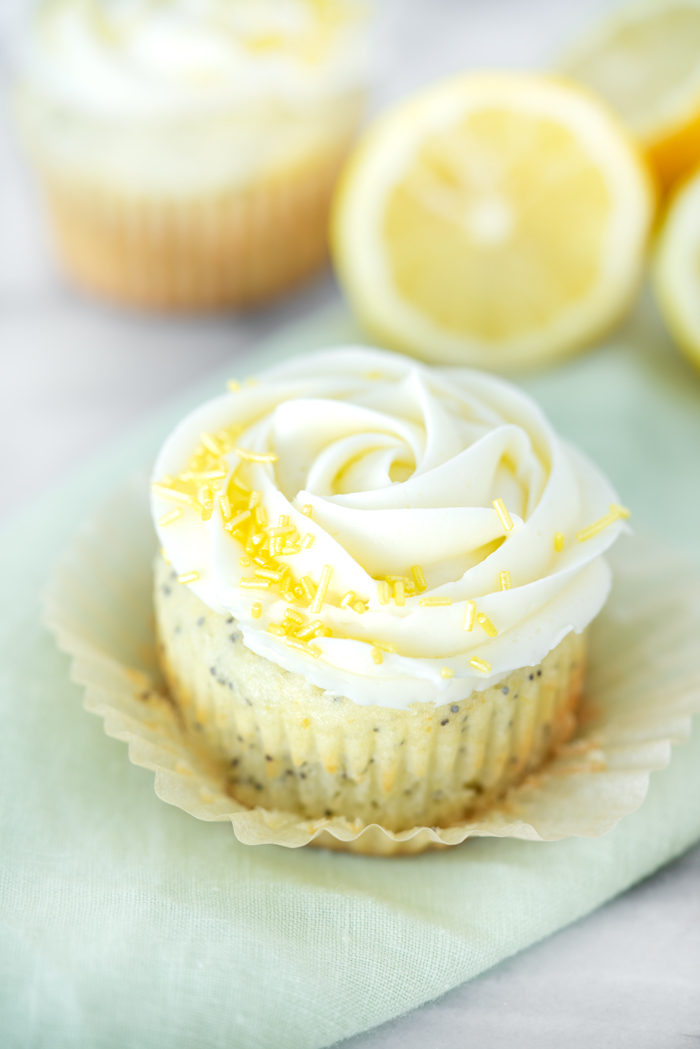 Lemon Poppy Seed Cupcakes. Bright lemony cupcakes speckled with poppy seeds, swirled with lemon buttercream. | thesugarcoatedcottage #cupcake #cake #lemon