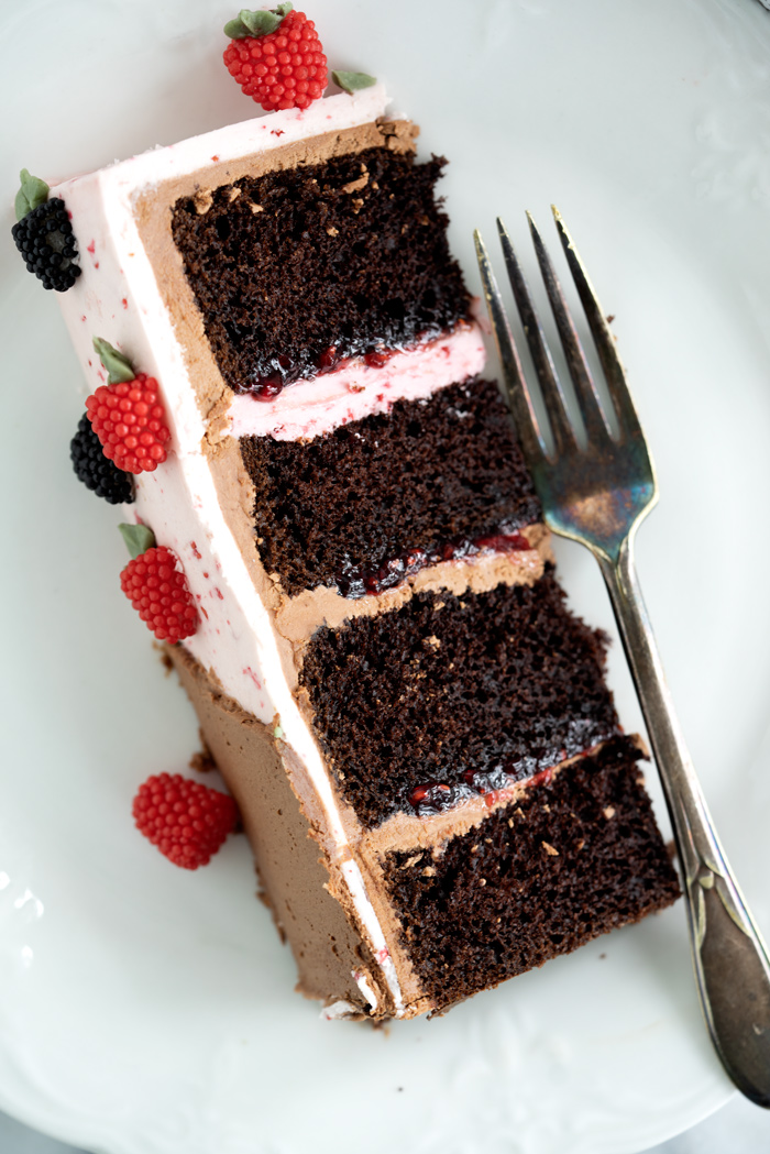 Raspberry Chocolate Cake. Addicting layers of deep chocolate cake. Filled with raspberry and both raspberry and chocolate buttercream! #cake #buttercream