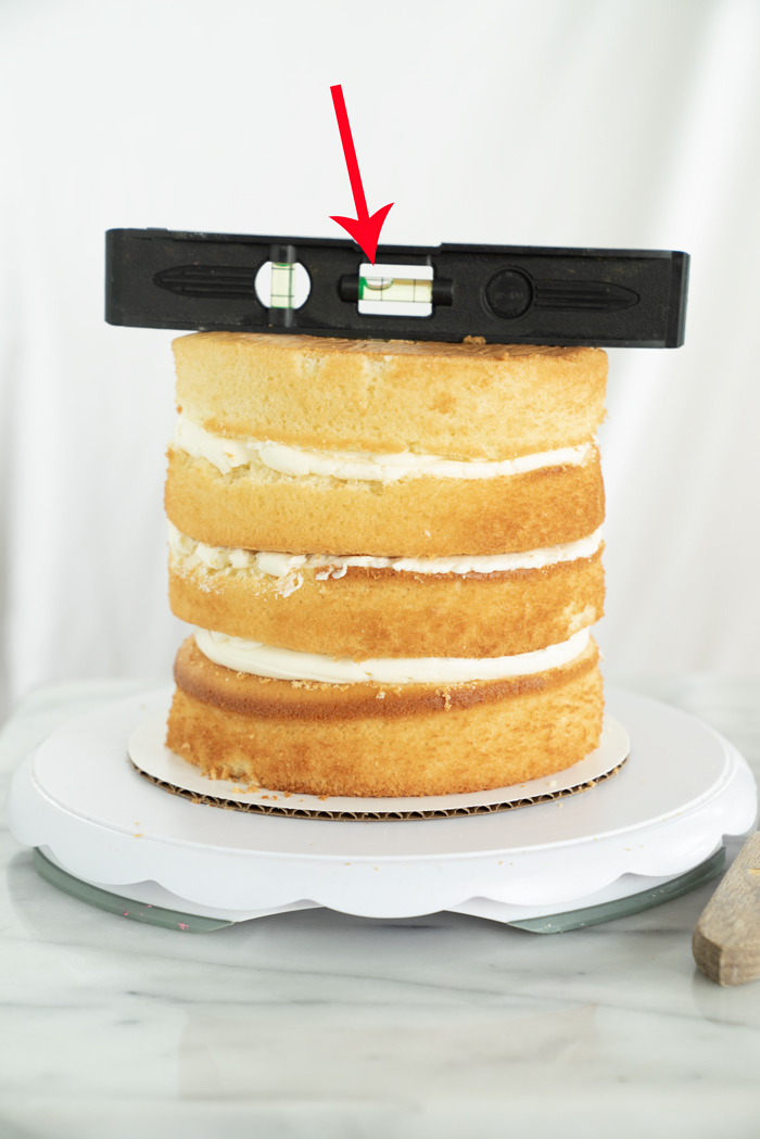 A step by step tutorial on how to properly fill and crumb coat a cake. thesugarcoatedcottage.com | #cake decorating, #crumb coat, #cake