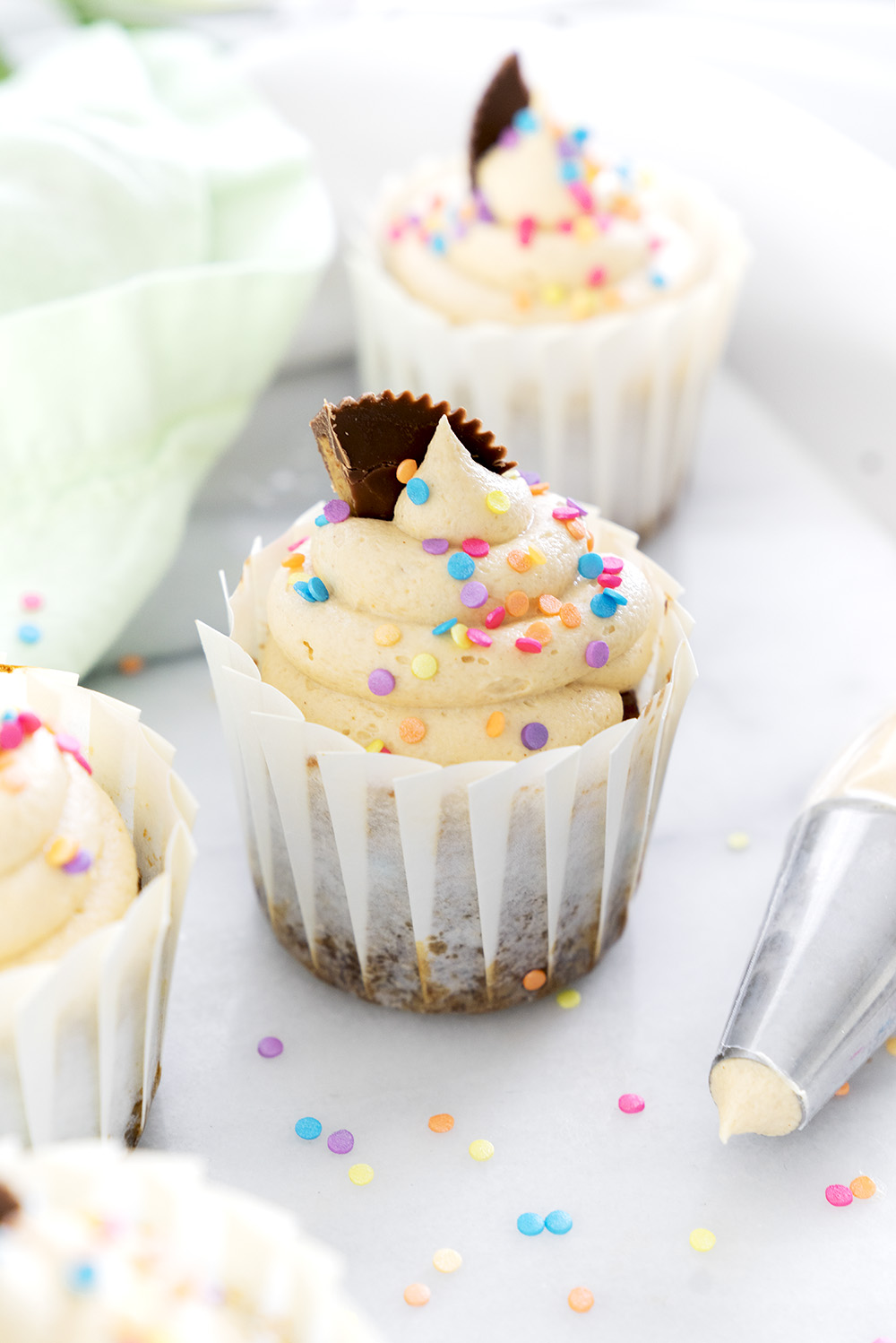 Banana Cupcakes with Peanut Butter Buttercream. Moist, delicious banana cupcakes and a swirl of peanut butter buttercream. #cupcake #banana #peanutbutter