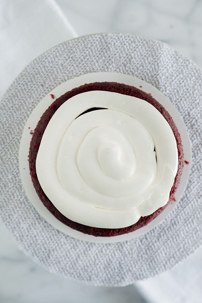 4th of July Red Velvet Cheesecake Cake. Moist, tender crumb red velvet cake with layers of whipped cheesecake filling. #4thofjuly #redvelvet #cheesecake #cake #redvelvetcheesecake
