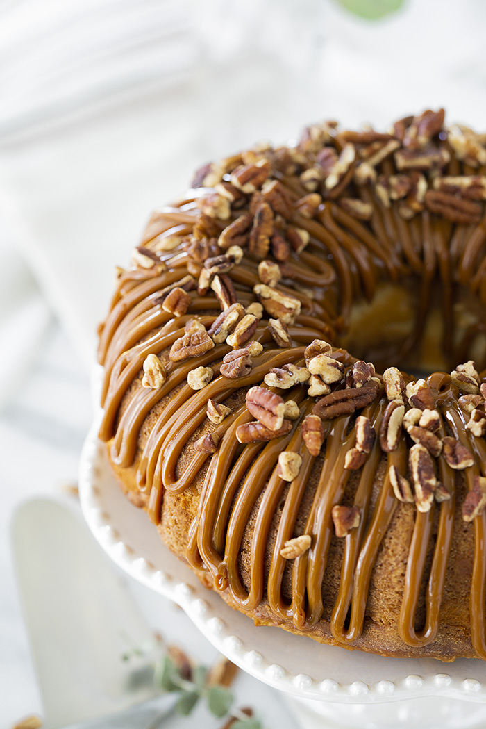 The Best Apple Spice Bundt Cake with Cream Cheese Filling and Dulce De Leche Glaze. | thesugarcoatedcottage.com #bundtcake #applecake #creamcheesefilling