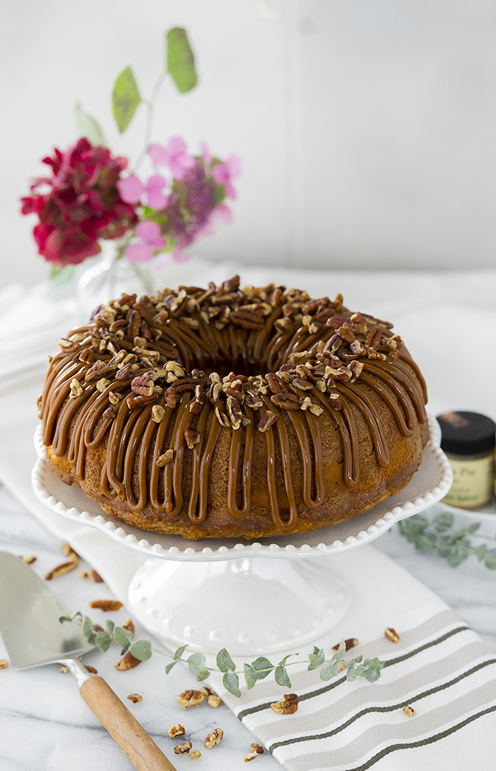 The Best Apple Spice Bundt Cake with Cream Cheese Filling and Dulce De Leche Glaze. | thesugarcoatedcottage.com #bundtcake #applecake #creamcheesefilling