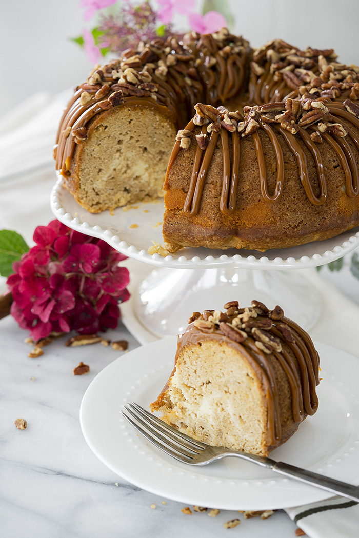 The Best Apple Spice Bundt Cake with Cream Cheese Filling and Dulce De Leche Glaze. | thesugarcoatedcottage.com #bundtcake #applecake #creamcheesefilling