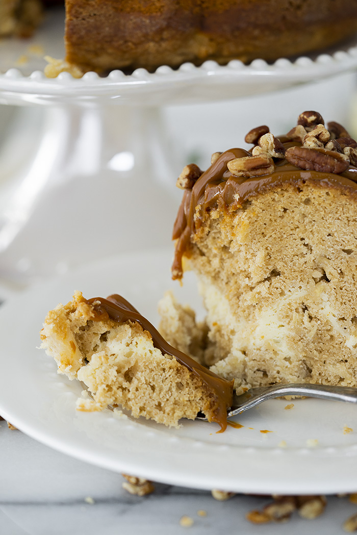 The Best Apple Spice Bundt Cake with Cream Cheese Filling and Dulce De Leche Glaze. | thesugarcoatedcottage.com #bundtcake #applecake #creamcheesefilling