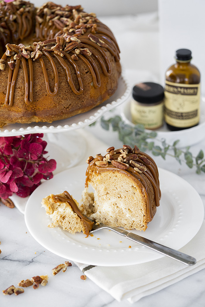 The Best Apple Spice Bundt Cake with Cream Cheese Filling and Dulce De Leche Glaze. | thesugarcoatedcottage.com #bundtcake #applecake #creamcheesefilling